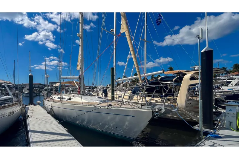Slide: The Image of Sailboats docked at marina under blue sky, featuring 1991 Oyster LW48 yacht. - 70