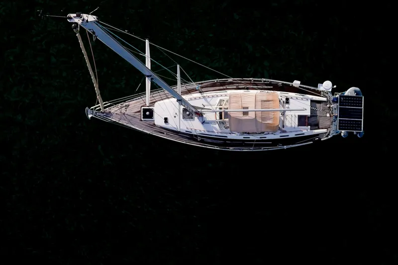 Slide: The Image of Aerial view of 1991 Oyster Lightwave 48 sailboat on dark water. - 76