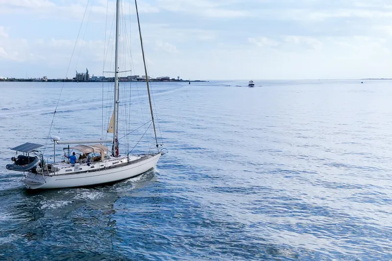 Slide: The Image of Sailboat Oyster Lightwave 48, 1991 model, cruising on calm waters under a clear sky. - 78