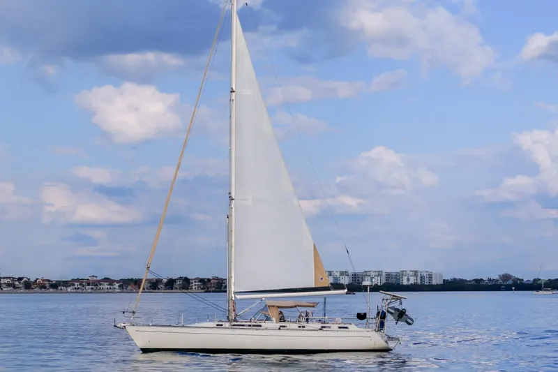 Slide: The Image of Sailboat Oyster Lightwave 48, 1991 model, cruising on calm waters under a blue sky. - 79