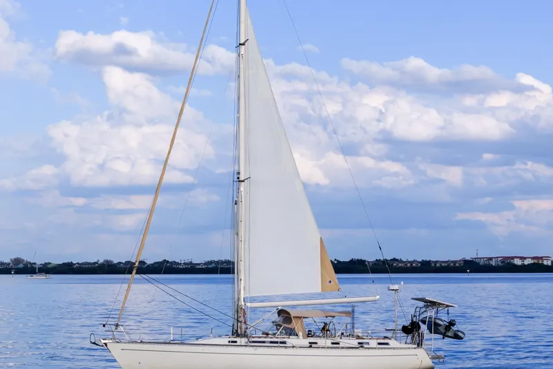 Slide: The Image of Sailboat Oyster Lightwave 48, 1991 model, cruising on calm waters under a blue sky. - 80