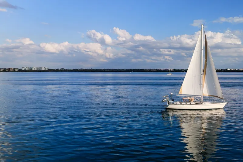 Slide: The Image of Sailboat Oyster Lightwave 48, 1991, gliding on calm blue waters under a clear sky. - 84
