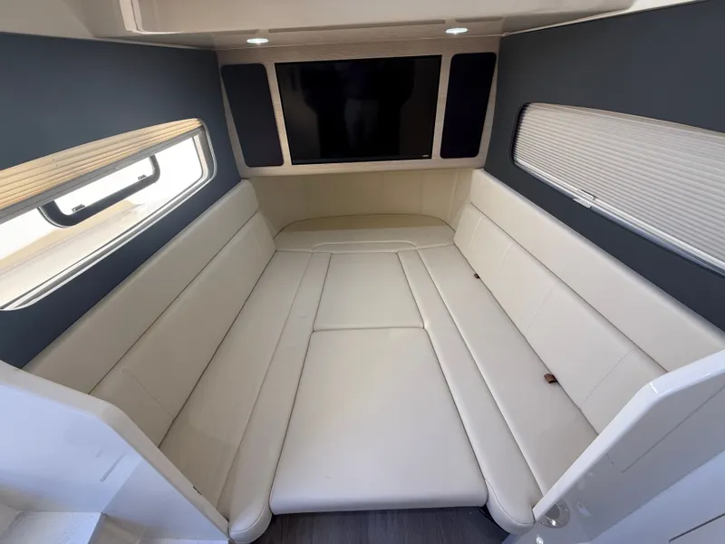 Slide: The Image of Interior of 2026 Scout 400 LXF with beige sofa and window. - 12
