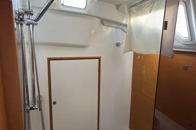 Slide: The Image of Interior of 2018 Jeanneau Sun Odyssey 389 yacht bathroom with shower and wooden accents. - 11