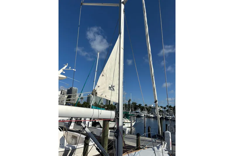 Slide: The Image of 2018 Jeanneau Sun Odyssey 389 sailboat docked at marina under clear blue sky. - 21