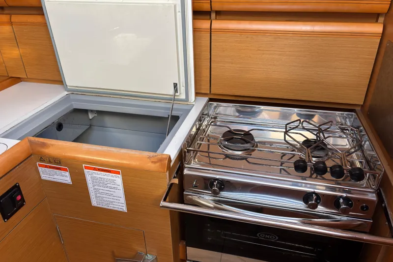 Slide: The Image of Galley kitchen in 2018 Jeanneau Sun Odyssey 389 yacht with stove and storage. - 8