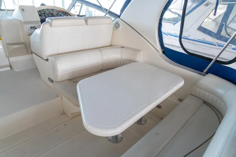 Slide: The Image of 2000 Cruisers Yachts 3375 Express interior with white seating and table. - 11