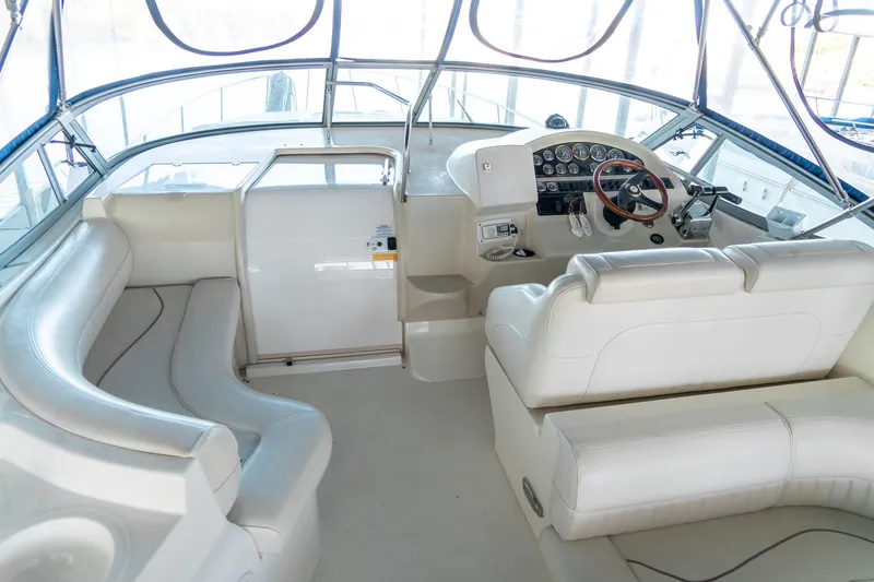 Slide: The Image of Interior of 2000 Cruisers Yachts 3375 Express with white seating and helm. - 14