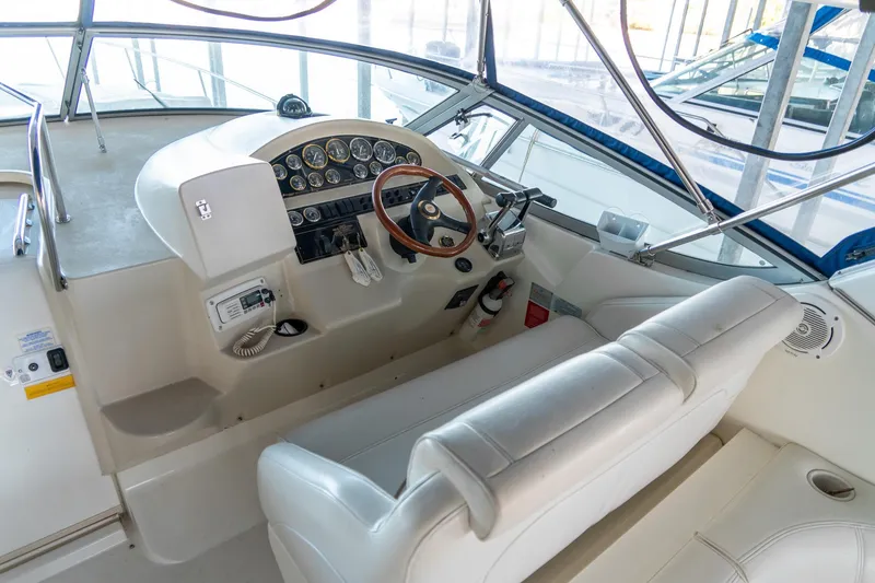 Slide: The Image of 2000 Cruisers Yachts 3375 Express helm with gauges, steering wheel, and seating. - 15