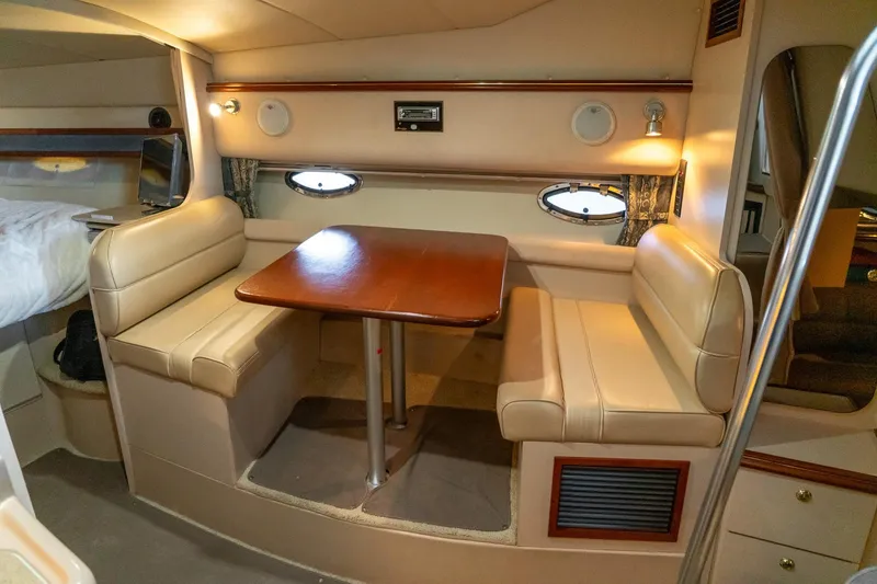 Slide: The Image of 2000 Cruisers Yachts 3375 Express interior with dining area and beige seating. - 22