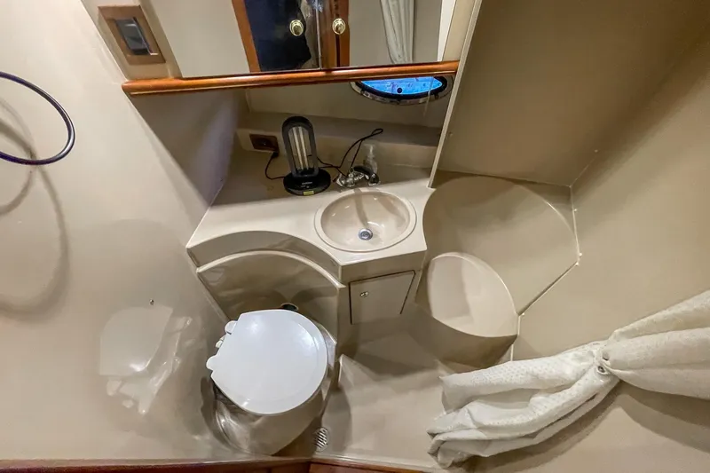 Slide: The Image of Bathroom interior of 2000 Cruisers Yachts 3375 Express, featuring sink and toilet. - 32