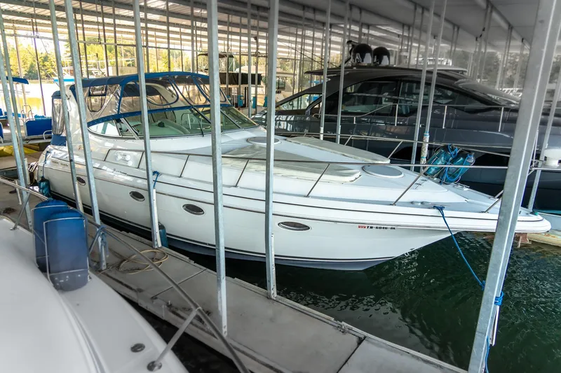 Slide: The Image of 2000 Cruisers Yachts 3375 Express docked in a covered marina. - 6