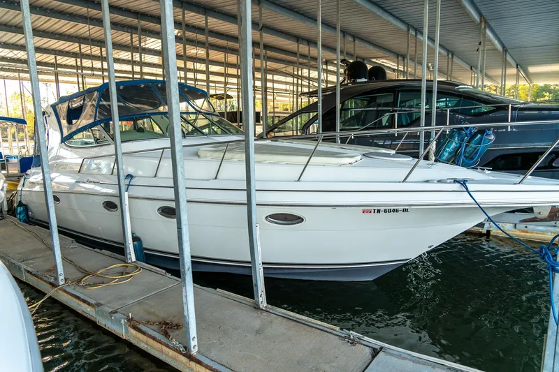 Slide: The Image of 2000 Cruisers Yachts 3375 Express docked in a covered marina. - 7