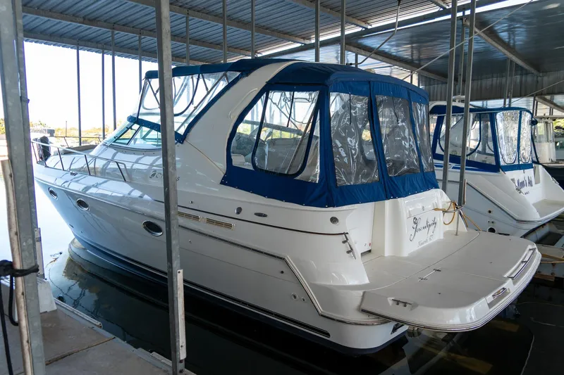 Slide: The Image of 2000 Cruisers Yachts 3375 Express docked under a covered marina. - 5