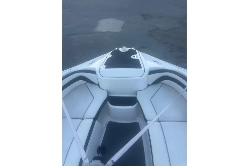 The Image of 2015 Yamaha Boats AR240 HO bow interior with seating and storage. - 1