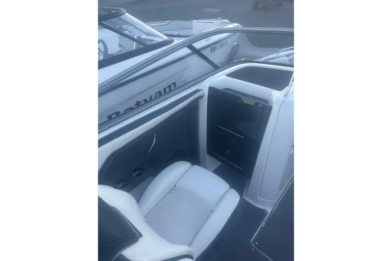 Slide: The Image of 2015 Yamaha Boats AR240 HO interior with white seating and storage compartment. - 10