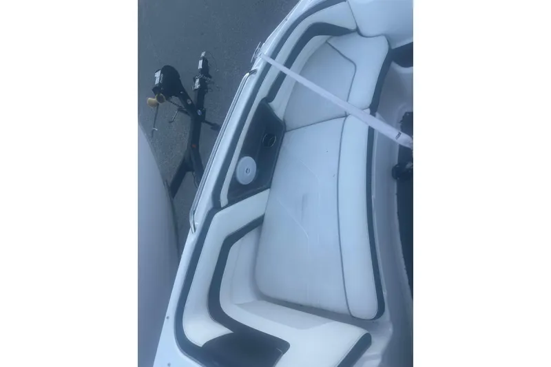 Slide: The Image of 2015 Yamaha AR240 HO boat interior with white seating and trailer. - 4