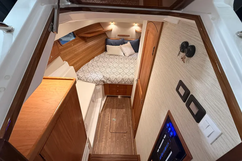 Slide: The Image of Luxurious cabin interior of 2026 MJM 38R yacht with cozy bed and wooden finishes. - 16