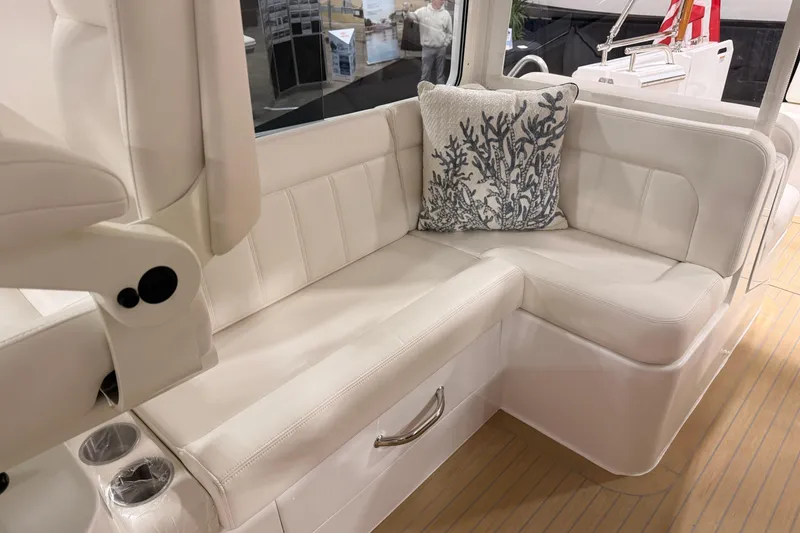 Slide: The Image of Luxurious seating area on 2026 MJM 38R boat with elegant white upholstery and decorative pillow. - 21