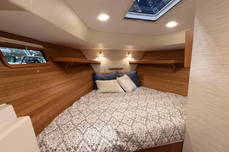 Slide: The Image of Cozy cabin interior of 2026 MJM 38R yacht with wood paneling and skylight. - 23