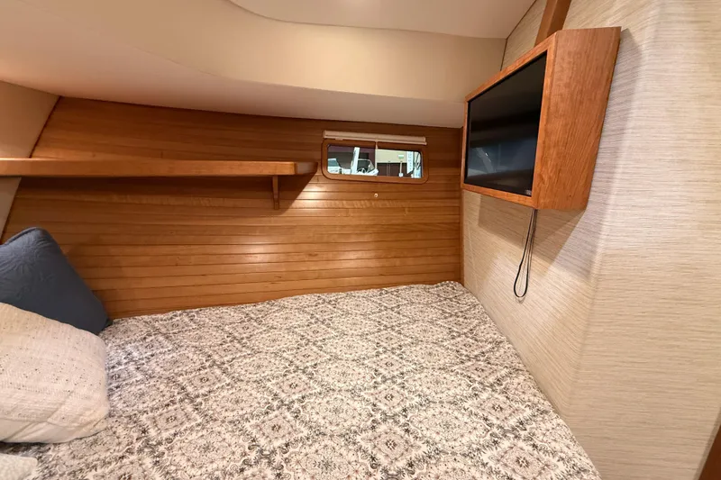 Slide: The Image of Cozy cabin interior of 2026 MJM 38R with wood paneling and mounted TV. - 27