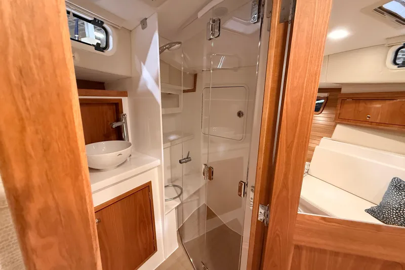Slide: The Image of Luxurious 2026 MJM 38R yacht interior with modern bathroom and wooden accents. - 30
