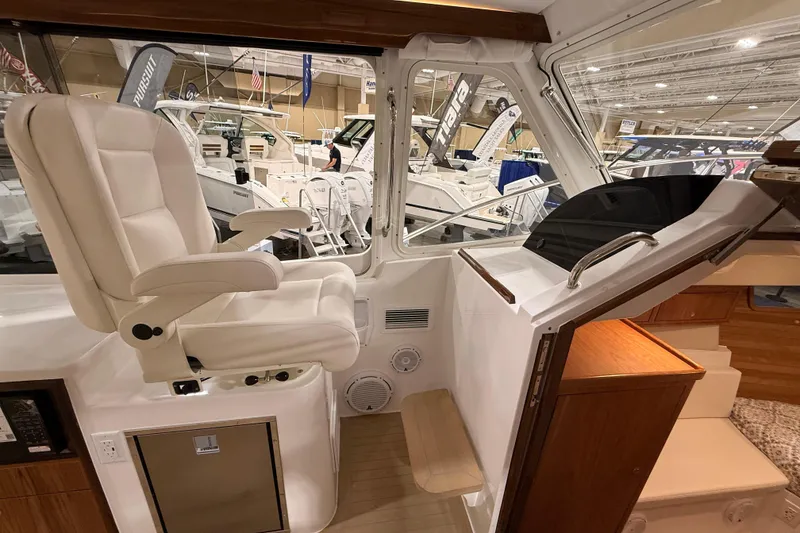 Slide: The Image of Interior of 2026 MJM 38R boat with white captain's chair and helm station. - 33