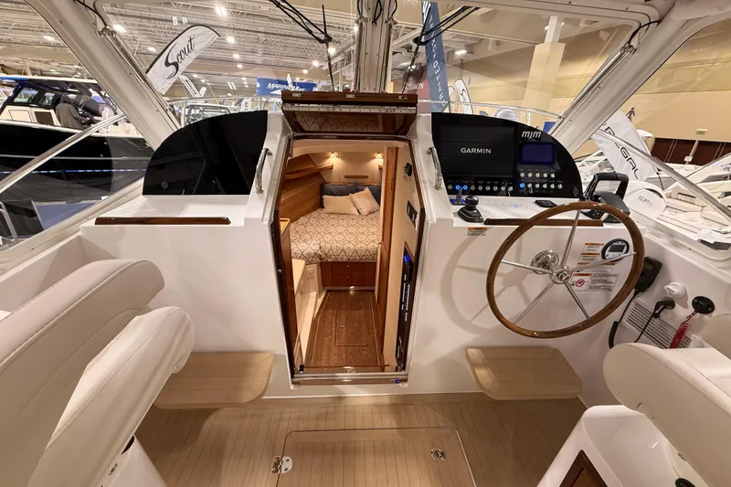 Slide: The Image of 2026 MJM 38R yacht interior with helm, Garmin navigation, and cozy cabin. - 34