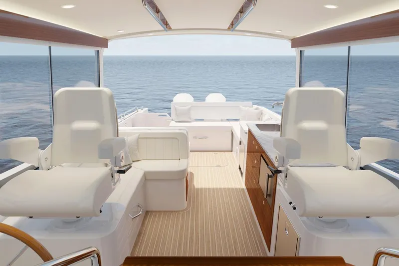 Slide: The Image of Luxurious interior of 2026 MJM 38R yacht with modern helm and kitchenette. - 9