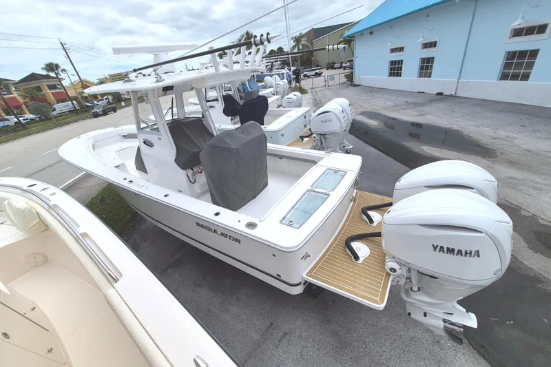 Slide: The Image of 2026 Regulator 28 boat with Yamaha engines, docked outdoors. - 13
