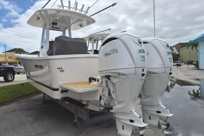 Slide: The Image of 2026 Regulator 28 boat with twin Yamaha 350 V8 engines, parked outdoors. - 17