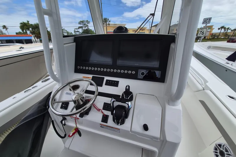 Slide: The Image of Helm of 2026 Regulator 28 boat with modern controls and navigation screens. - 20