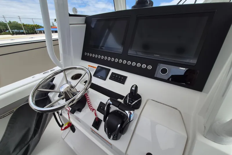 Slide: The Image of Helm of 2026 Regulator 28 boat with dual screens and modern controls. - 21