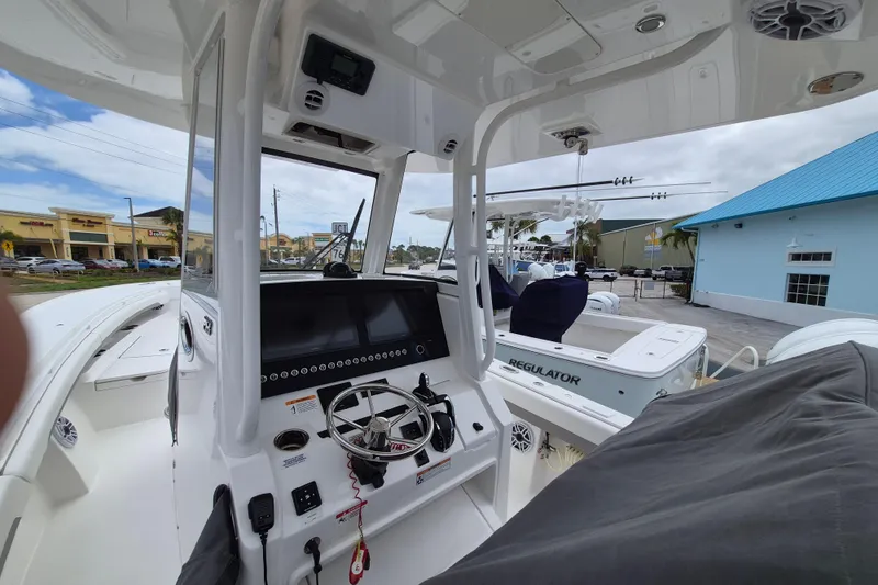 Slide: The Image of 2026 Regulator 28 boat interior with modern dashboard and steering wheel. - 22
