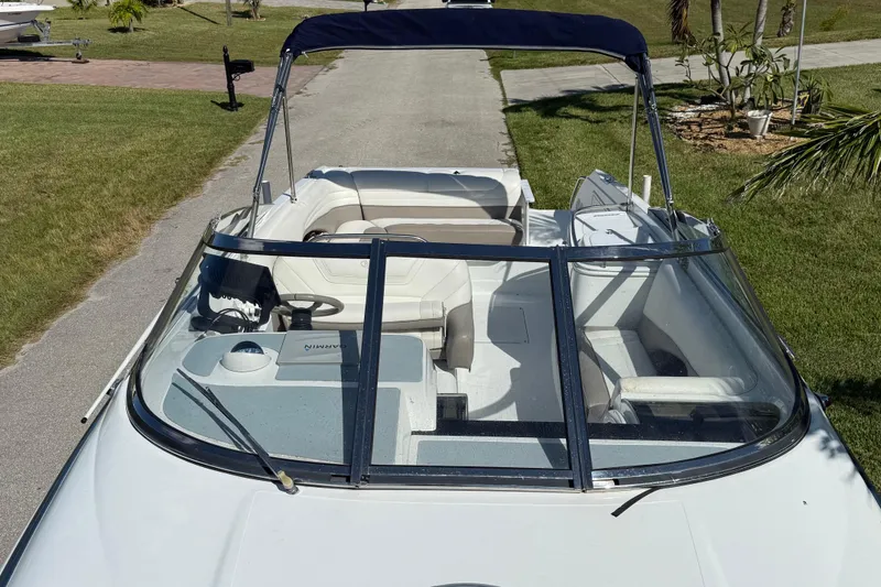 Slide: The Image of 1999 Cobalt 293 boat on trailer, parked in a suburban neighborhood. - 12