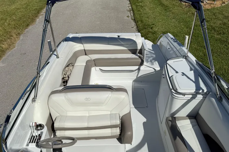 Slide: The Image of 1999 Cobalt 293 boat on trailer, parked on a sunny residential street. - 13