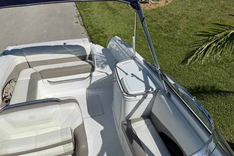 Slide: The Image of 1999 Cobalt 293 boat on trailer, parked on a sunny residential street. - 14