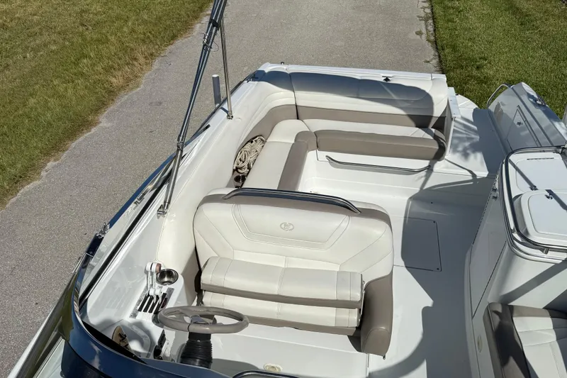 Slide: The Image of 1999 Cobalt 293 boat on trailer, parked on sunny street with palm trees. - 15