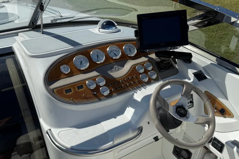 Slide: The Image of Bow view of a 1999 Cobalt 293 boat on a trailer, showing deck details. - 21