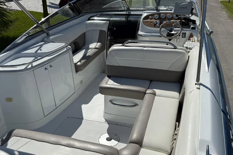 Slide: The Image of Cockpit of a 1999 Cobalt 293 boat with steering wheel and control panel. - 24