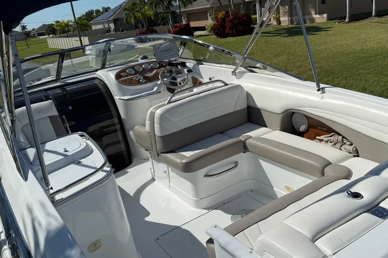 Slide: The Image of 1999 Cobalt 293 boat dashboard with gauges, steering wheel, and navigation screen. - 25