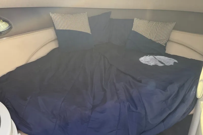 Slide: The Image of 1999 Cobalt 293 boat interior with white seating and steering console. - 30