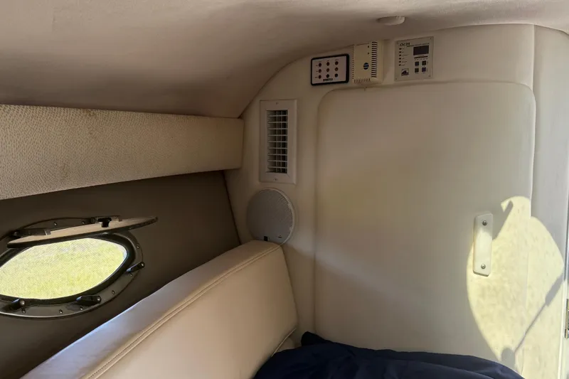 Slide: The Image of 1999 Cobalt 293 boat interior with white and beige seating, featuring a sleek design. - 31