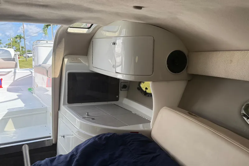 Slide: The Image of 1999 Cobalt 293 boat interior with seating and steering wheel under canopy. - 32