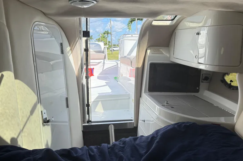 Slide: The Image of Interior of a 1999 Cobalt 293 boat with steering wheel and seating. - 33