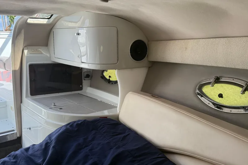 Slide: The Image of Interior cabin of 1999 Cobalt 293 boat with cozy bedding and pillows. - 34