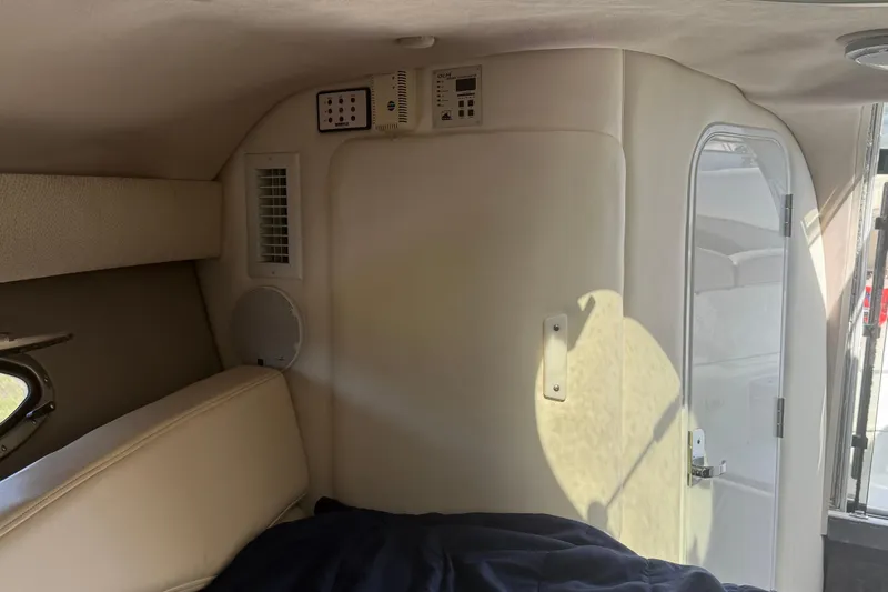 Slide: The Image of Interior cabin of a 1999 Cobalt 293 boat with porthole and control panels. - 35