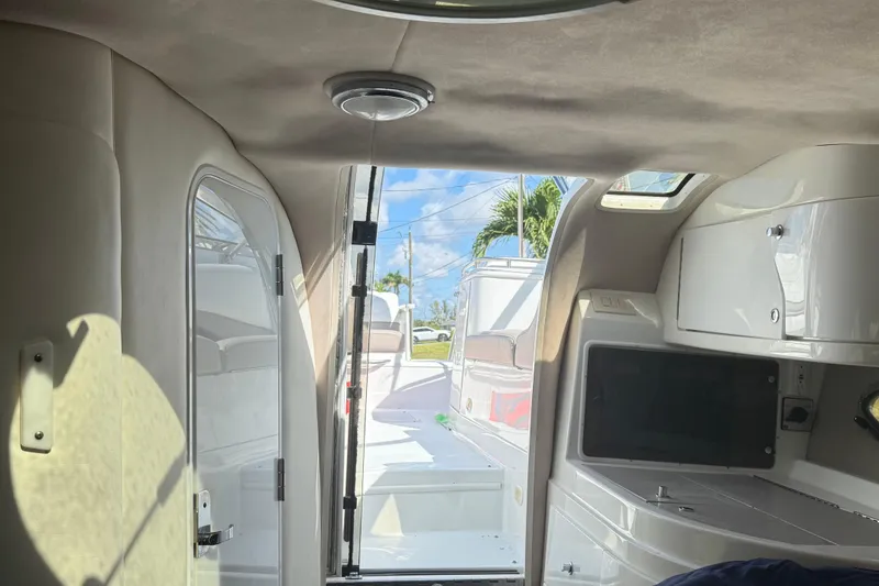 Slide: The Image of Interior cabin of a 1999 Cobalt 293 boat with storage and seating. - 36