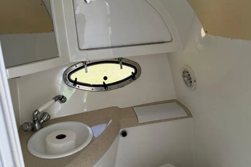 Slide: The Image of Interior view of a 1999 Cobalt 293 boat cabin with bed and storage. - 37