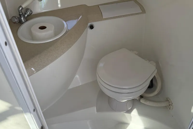 Slide: The Image of Interior cabin of a 1999 Cobalt 293 boat with storage and porthole. - 38